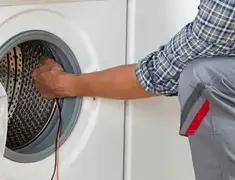 Dryer repair technician diagnosing and servicing a clothes dryer in Omaha, NE
