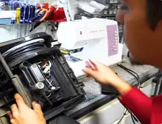 Vacuum repair technician servicing internal components on a workbench in Omaha, NE