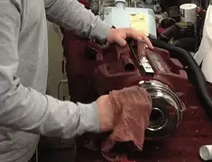 Vacuum repair technician cleaning and servicing a vacuum motor in Omaha, NE